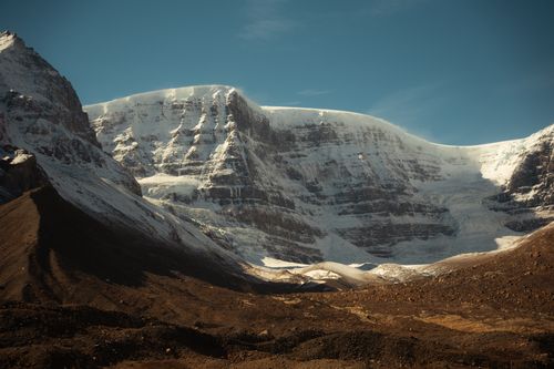 Free Stunning view of a snow-capped mountain range under clear blue skies. Stock Photo