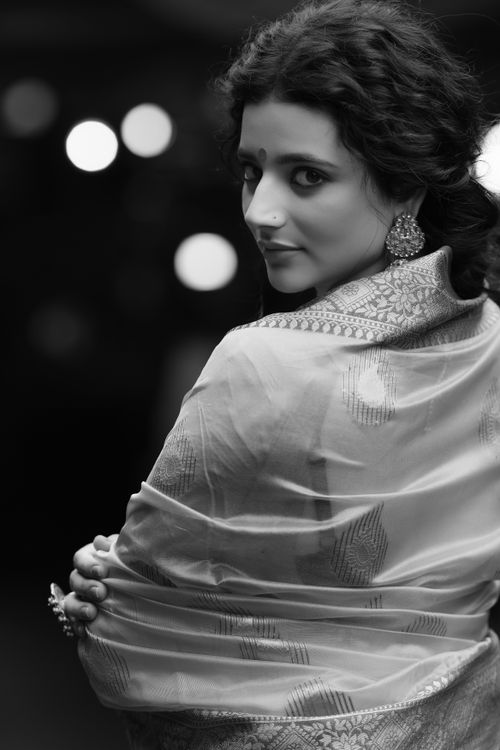 Free Black and white portrait of a woman in traditional attire with a bokeh background. Stock Photo
