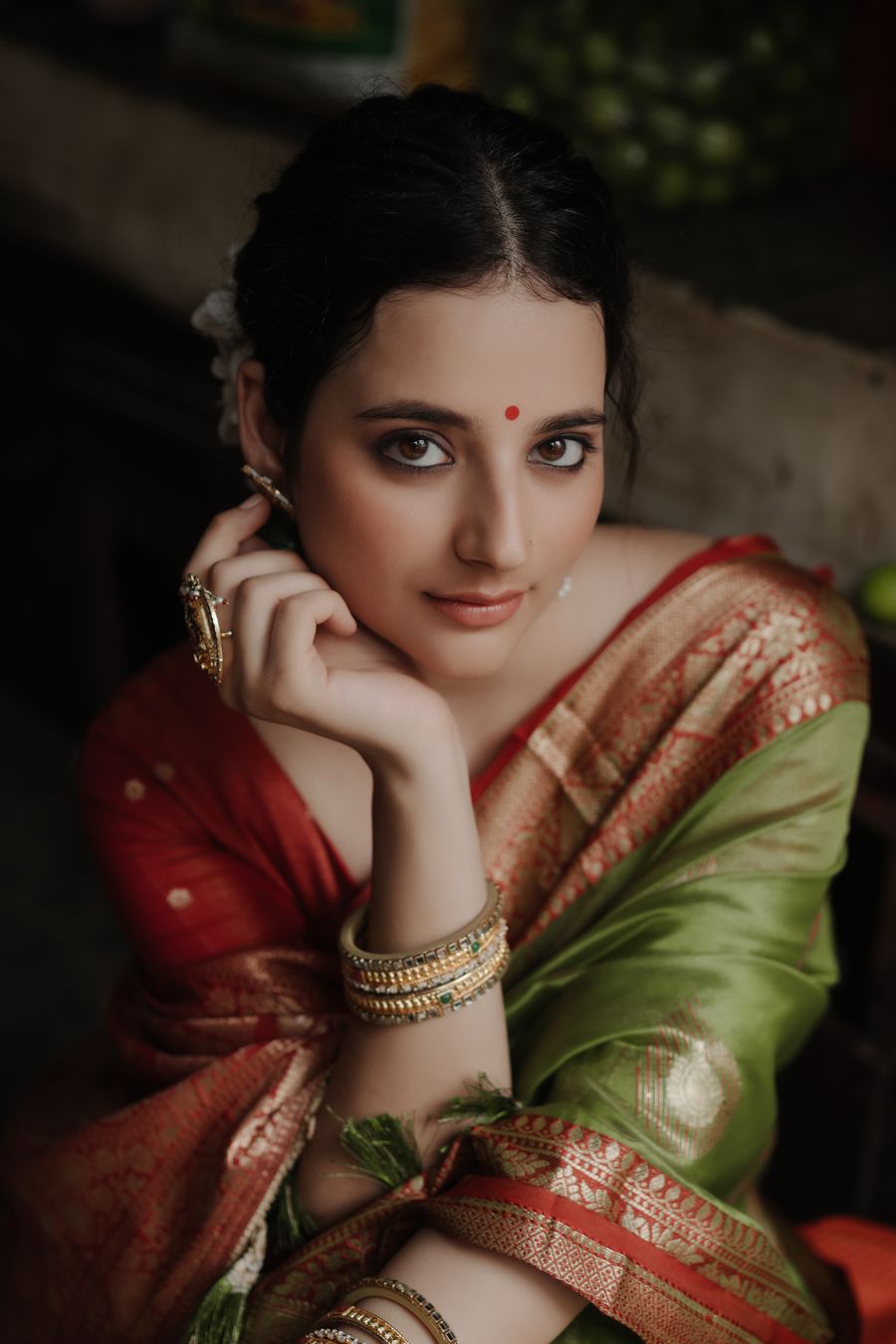 Woman in a red silk saree with gold jewellery