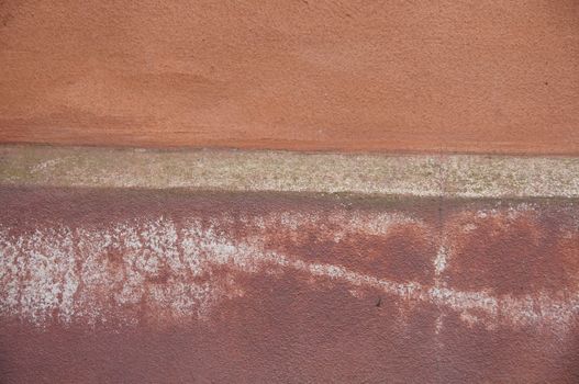 Close-up of a textured weathered wall with earthy tones and natural patterns.