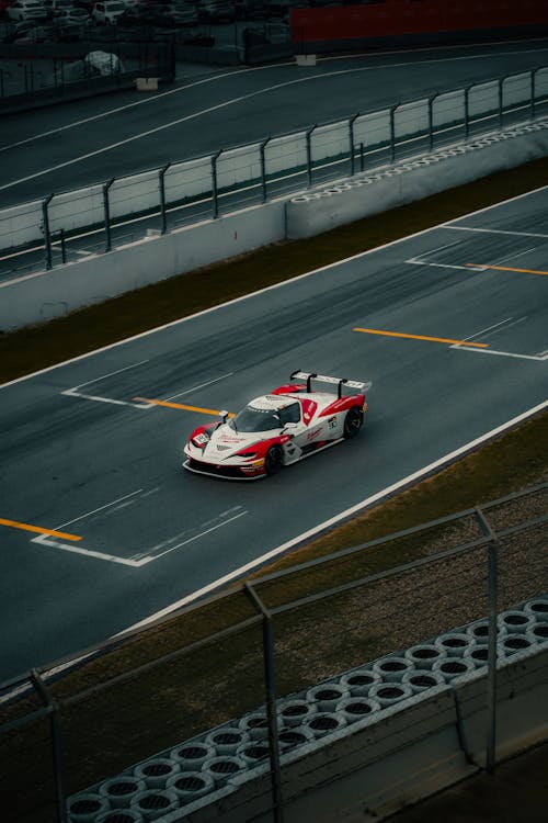 High-speed racing car on professional racetrack · Free Stock Photo