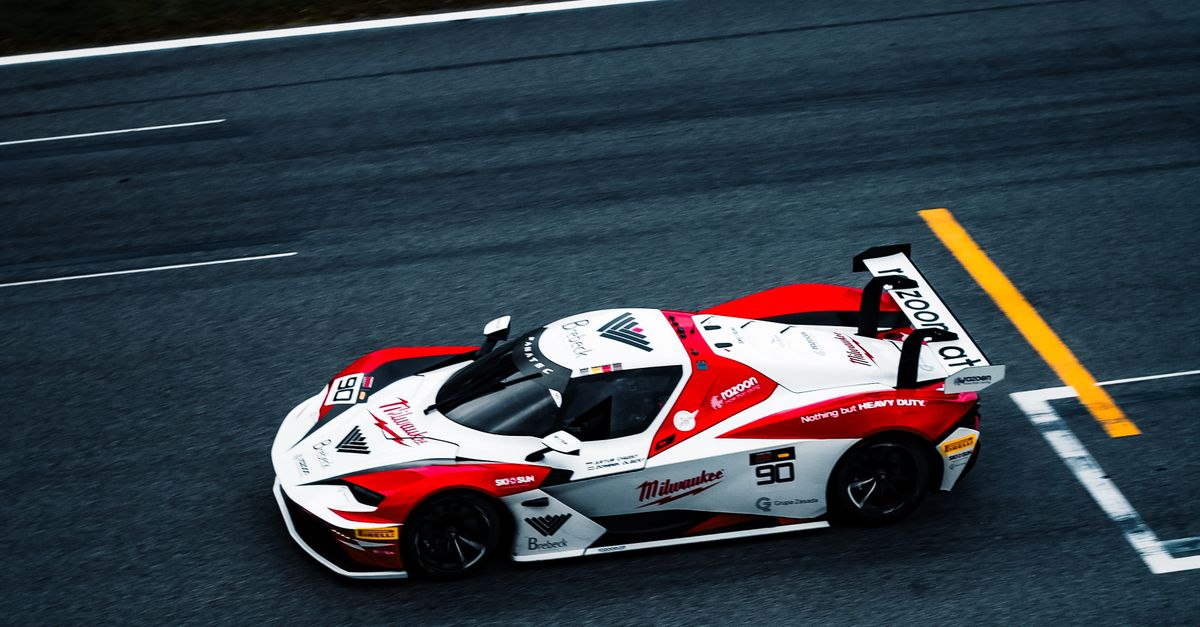 High Speed Racing Car High-speed race car on a track close-up · Free Stock Photo