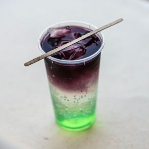 Layered dark cola drink over ice, photo by Kunal Lakhotia on Pexels