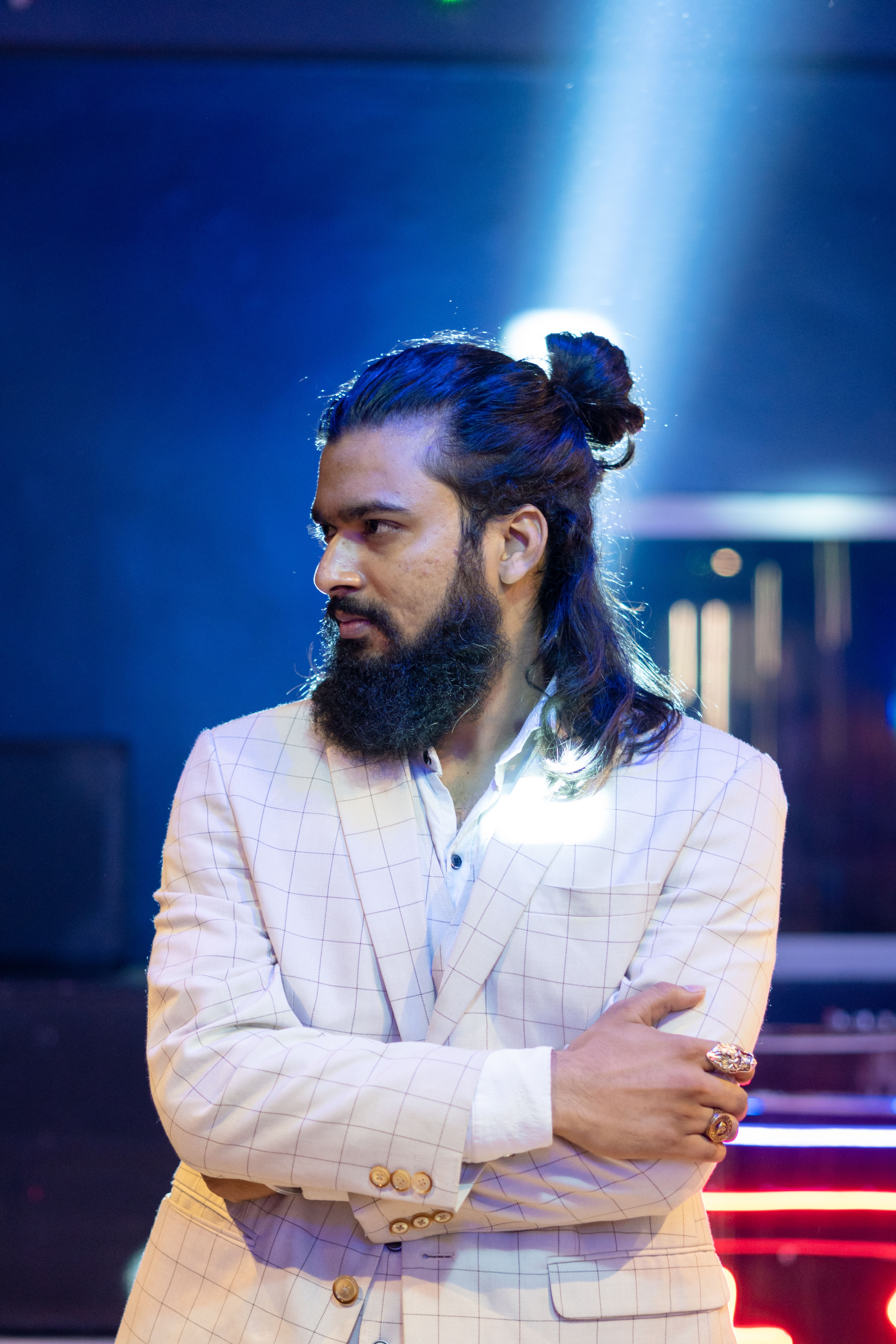 Stylish Man with Long Hair in Setting · Free Stock Photo