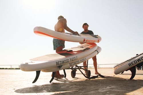 Two Men Standing Beside Surfboards