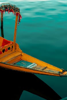 A vibrant yellow shikara boat on the tranquil waters of Dal Lake in Srinagar.