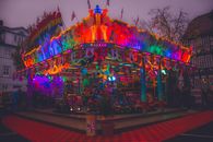Colorful carnival ride at night with vibrant lights and a fun atmosphere.