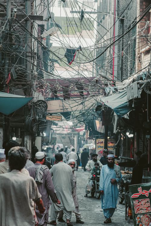 Free Vibrant Asian street market bustling with activity and colorful stalls. Stock Photo