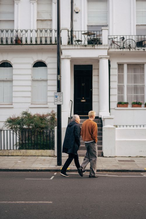 Free Elderly couple strolling in a classic London neighborhood, capturing urban life and architecture. Stock Photo