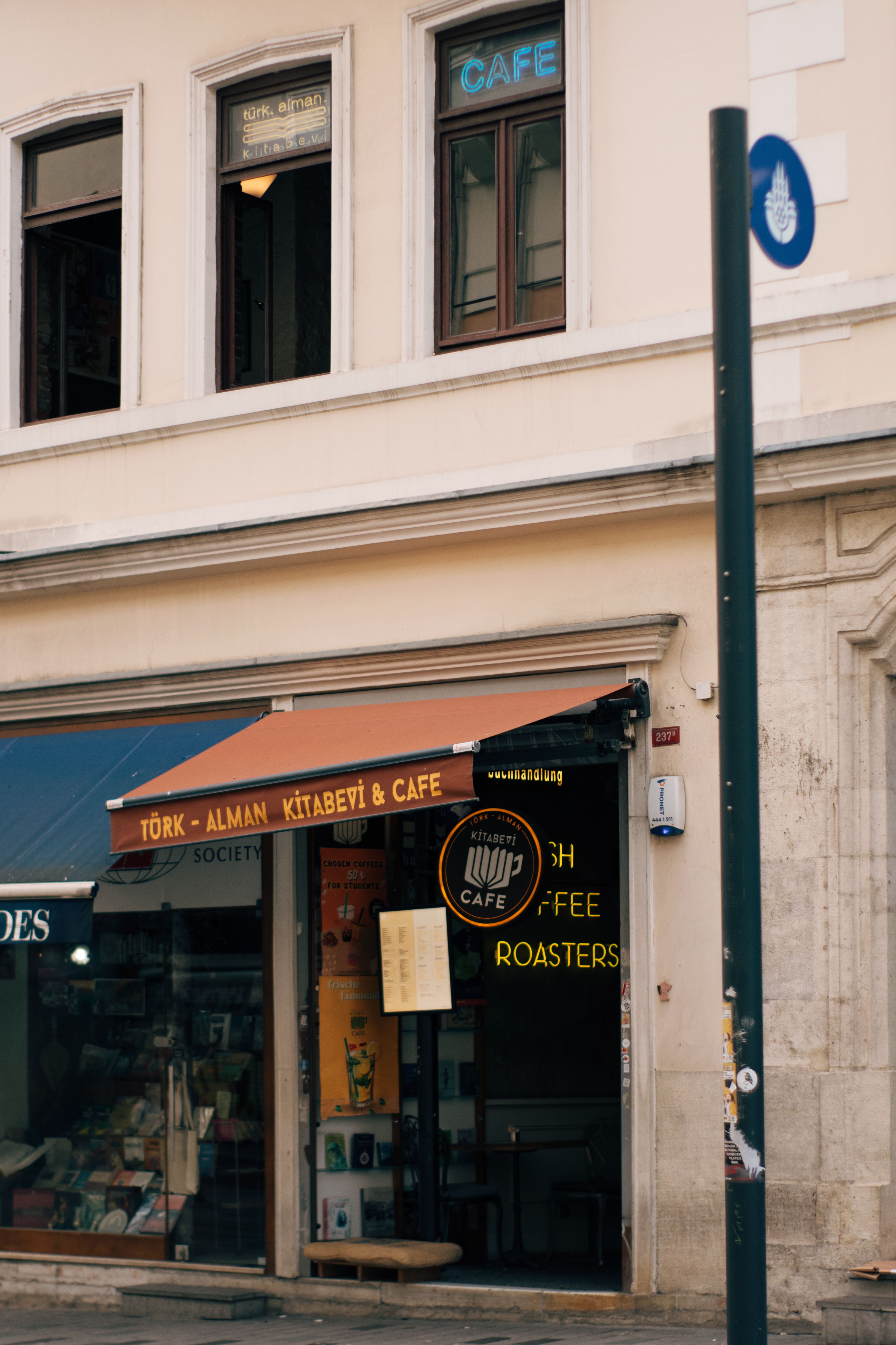 Charming Café Entrance with Vintage Awning · Free Stock Photo