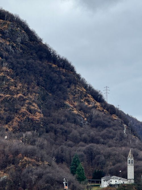 Free A picturesque mountain landscape in Piantedo, Lombardia, Italy, featuring a church tower and rugged terrain. Stock Photo