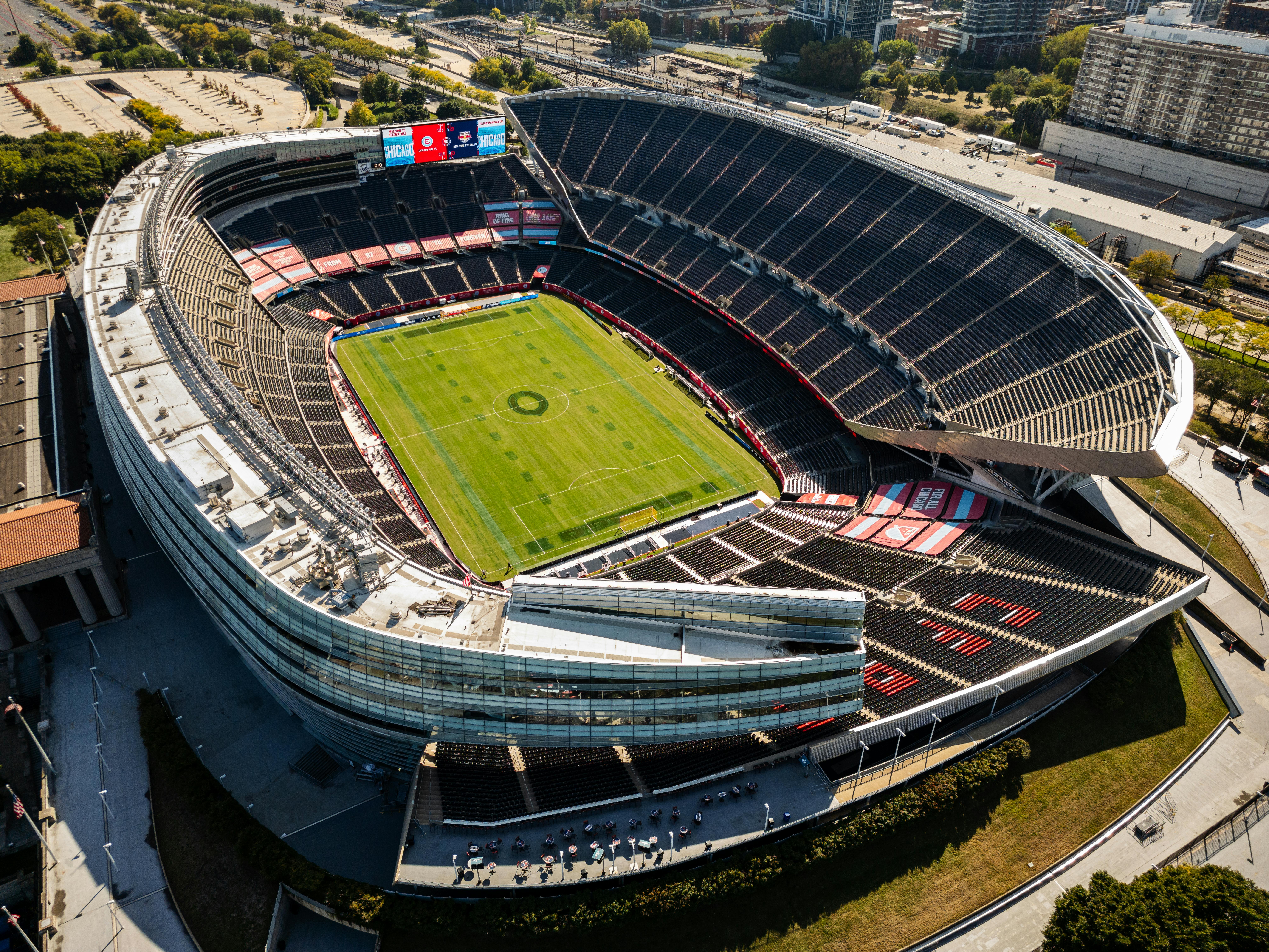 Aerial view of urban soccer stadium, hinting at smart city