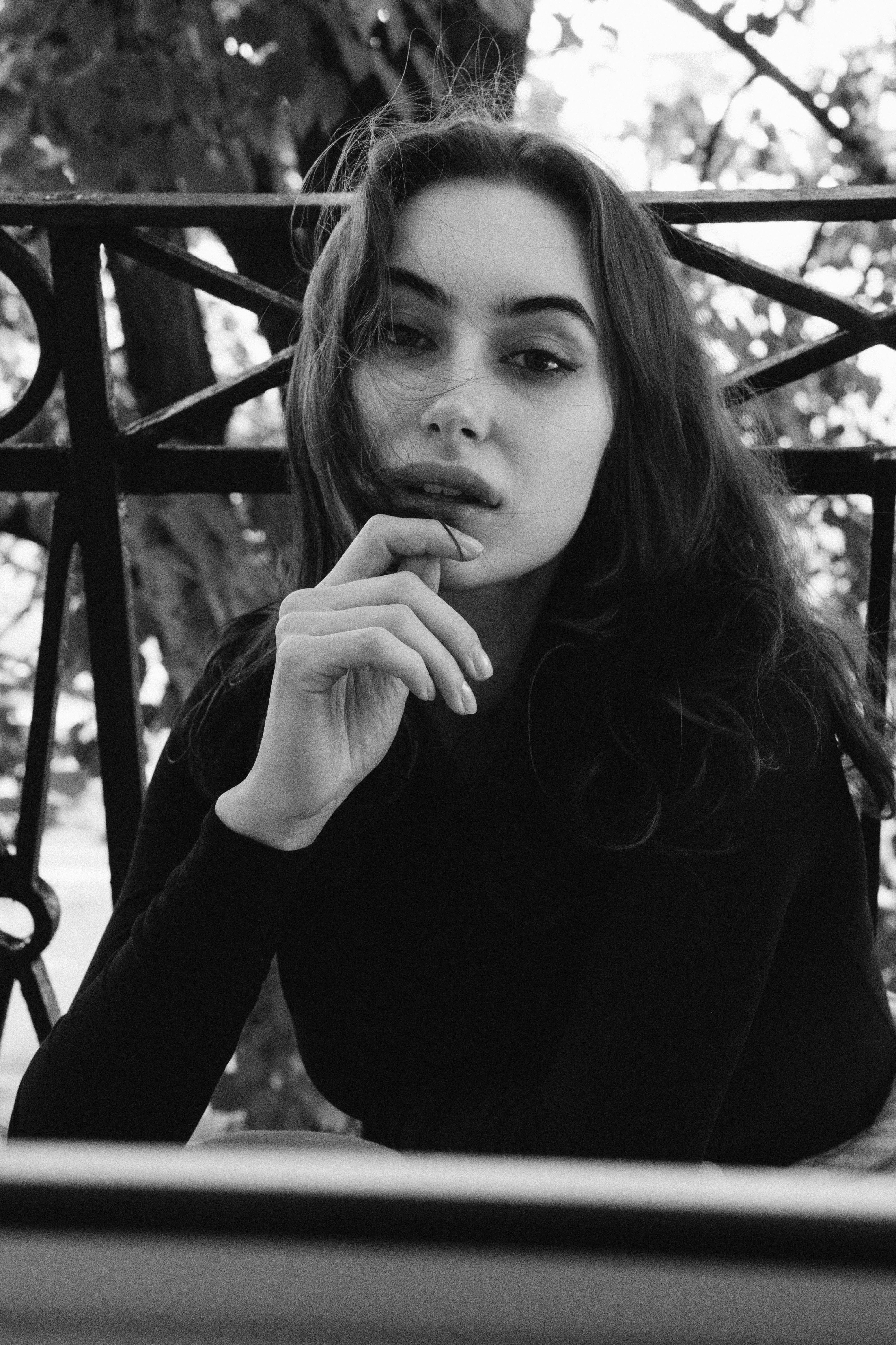 Striking black and white portrait of a woman with a thoughtful expression, perfect for editorial use.