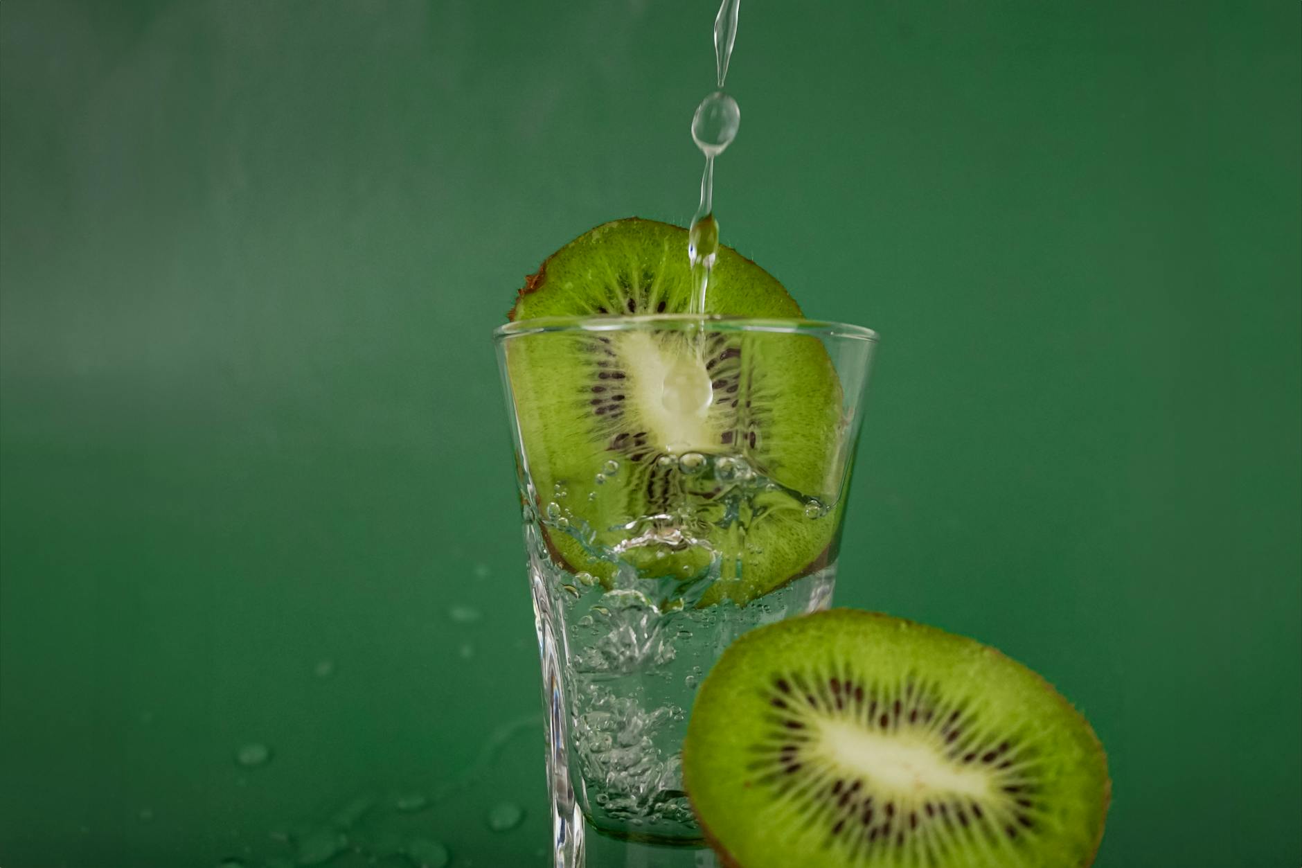 Refreshing Kiwi Splash in Glass with Water