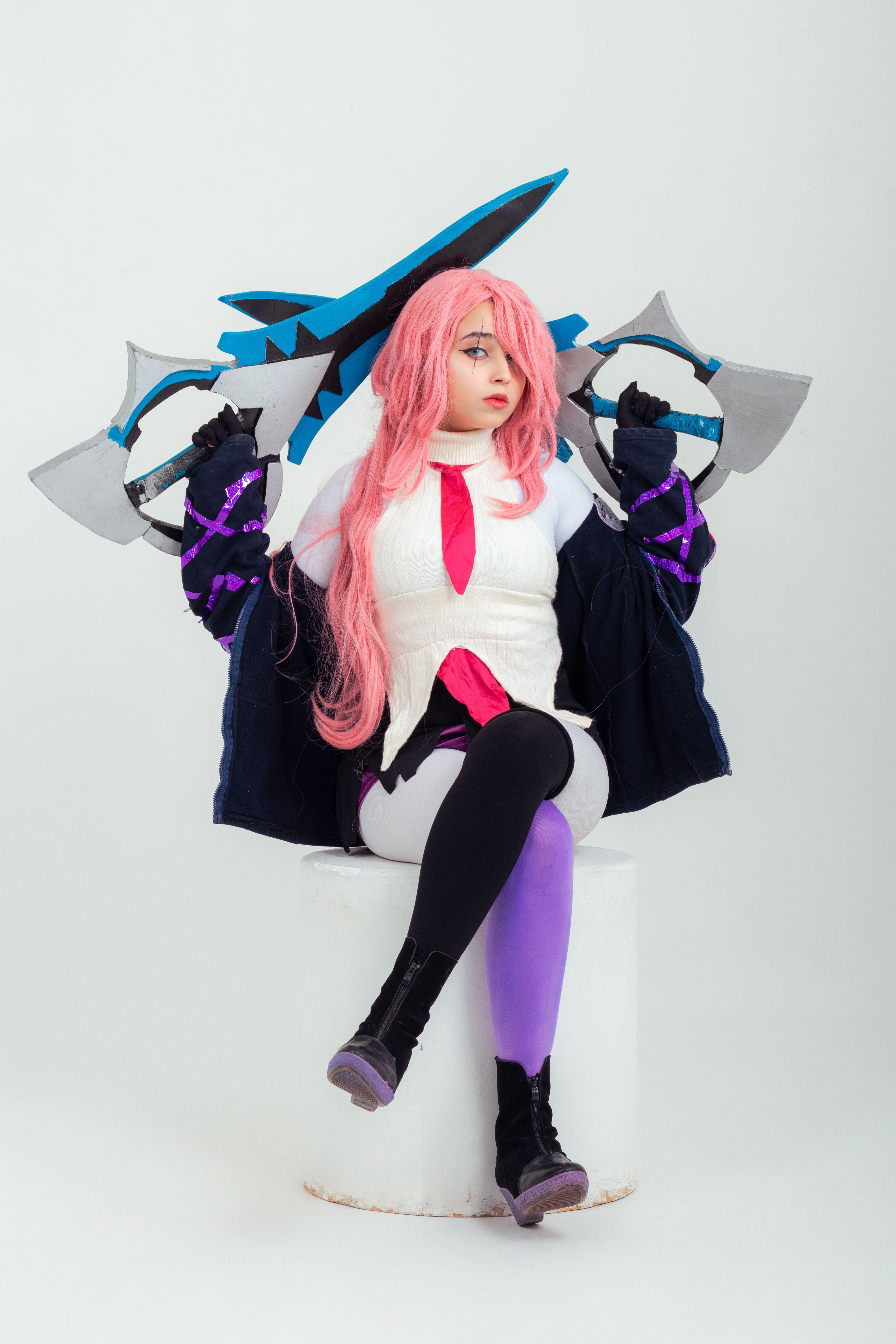Anime cosplay portrait featuring a character with vibrant pink hair and unique weaponry.