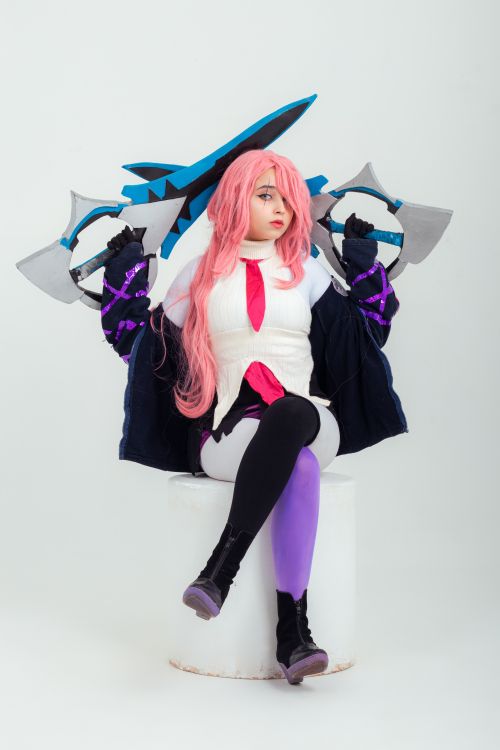 Free Anime cosplay portrait featuring a character with vibrant pink hair and unique weaponry. Stock Photo