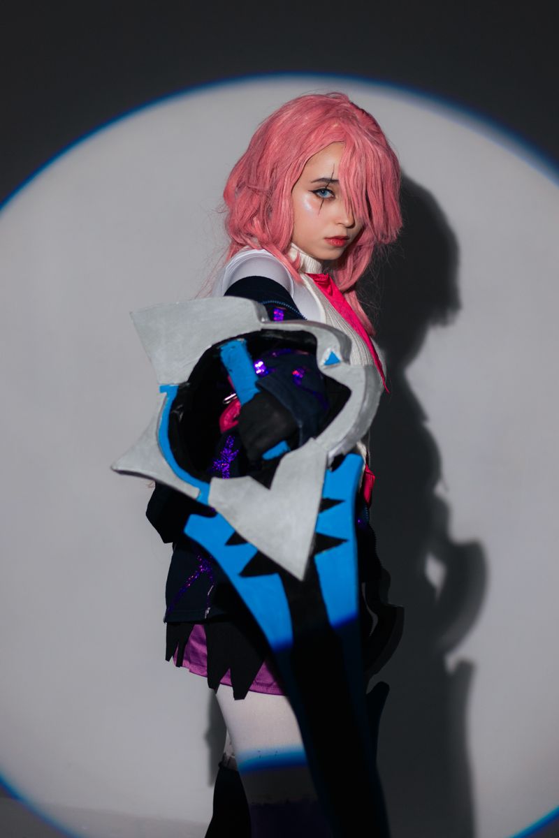 A dynamic studio portrait showcasing detailed anime cosplay with bold colors.