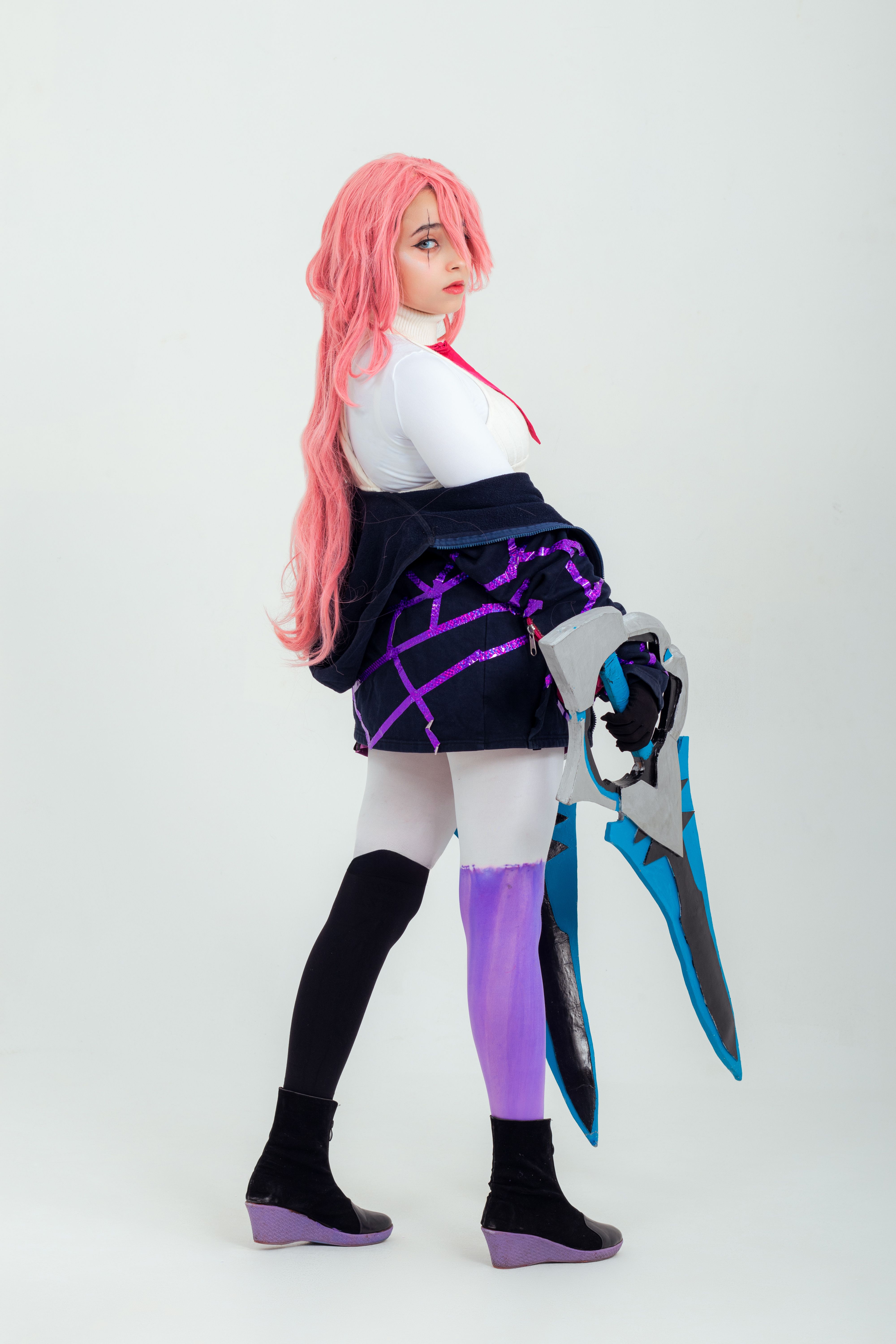 Colorful anime cosplay character captured in a studio environment, showcasing detailed costume design.