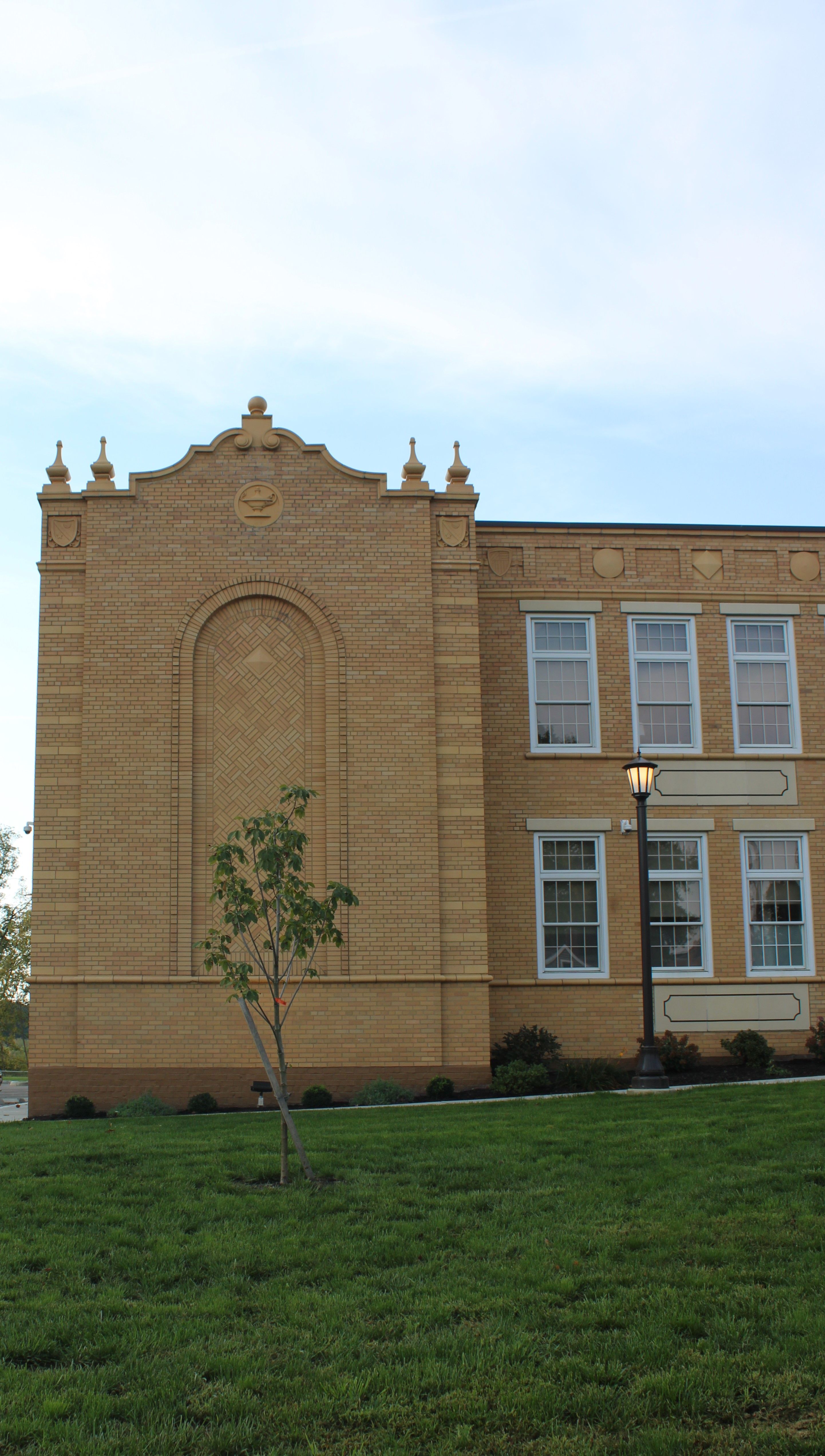 Classic architectural school building with decorative brickwork, standing against a serene sky.