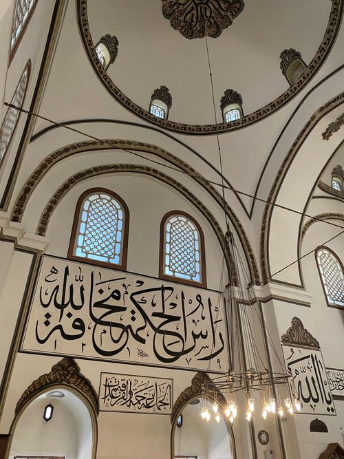 Free Beautiful interior of a mosque in Bursa, Turkey, showcasing Islamic calligraphy on the walls. Stock Photo