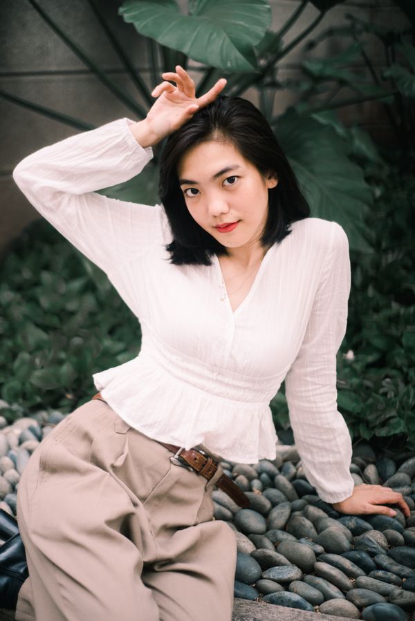 Ivory silk blouse tucked into burgundy midi skirt