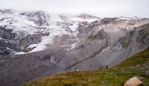 Free Serene view of Mount Rainier's snow-covered glacier and rugged terrain. Stock Photo
