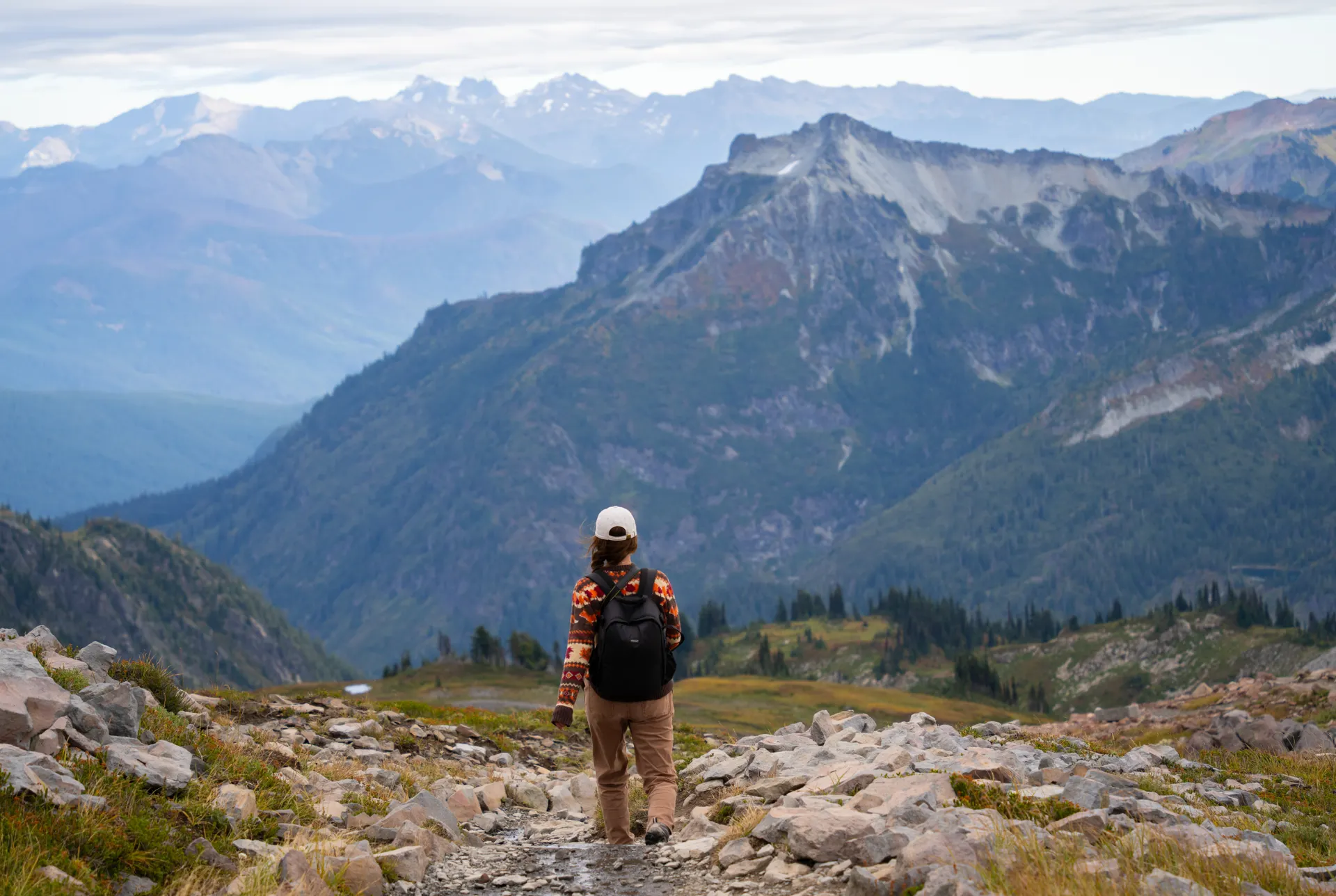 Woman hiking a trail in Mount Rainier National Park, Washington Woman hiking a trail in Mount Rainier National Park, Washington