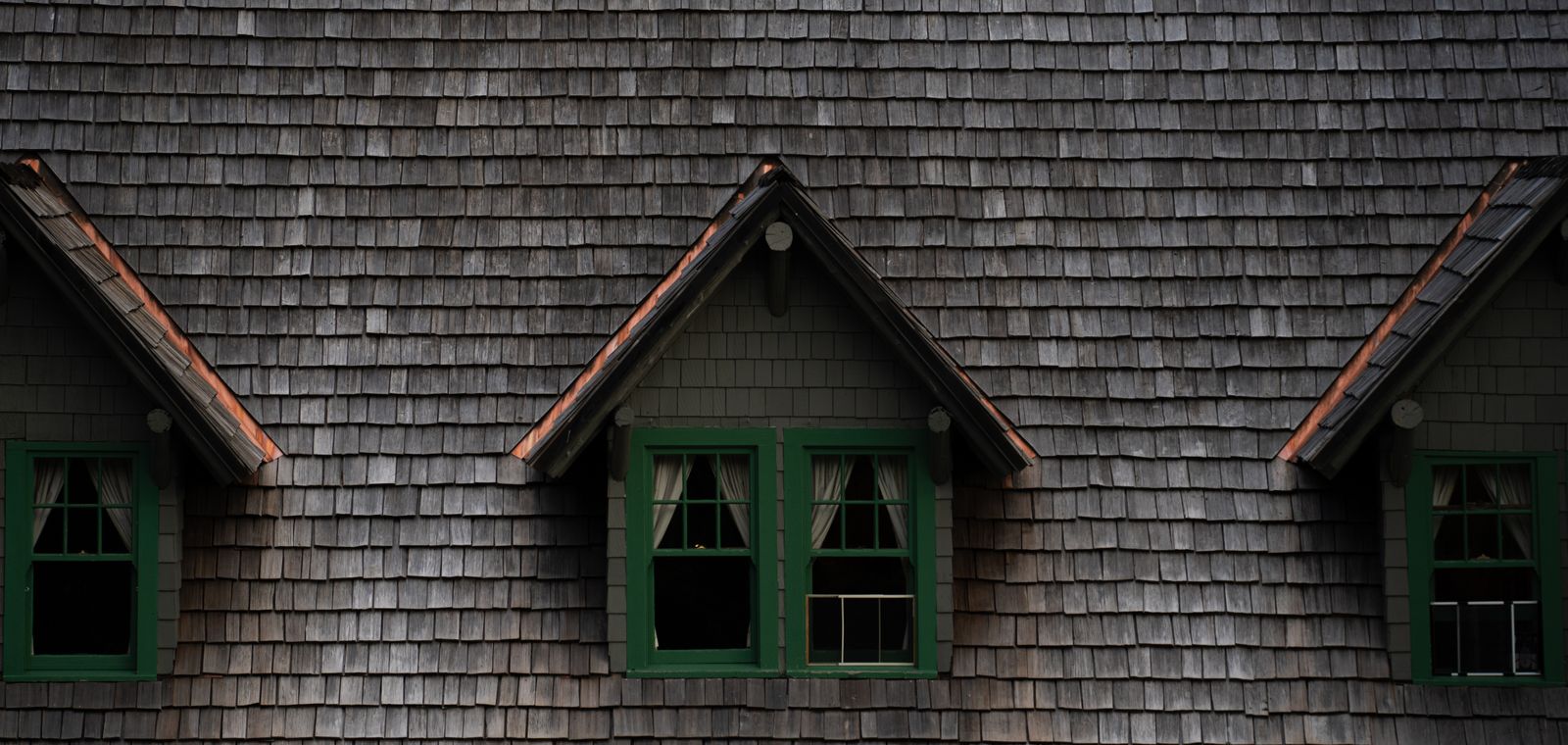 Historic building with a wood shingle roof and dormers
