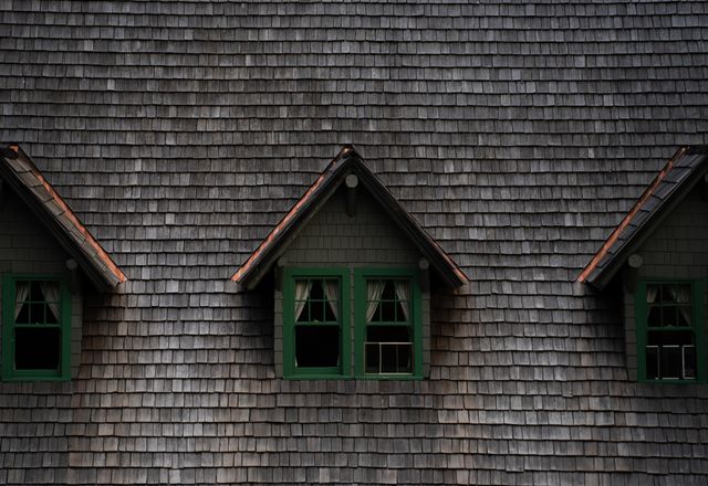 Historic building with a wood shingle roof and dormers
