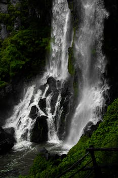 Discover the vibrant and powerful waterfall in Zacatlán, Mexico, surrounded by lush greenery.