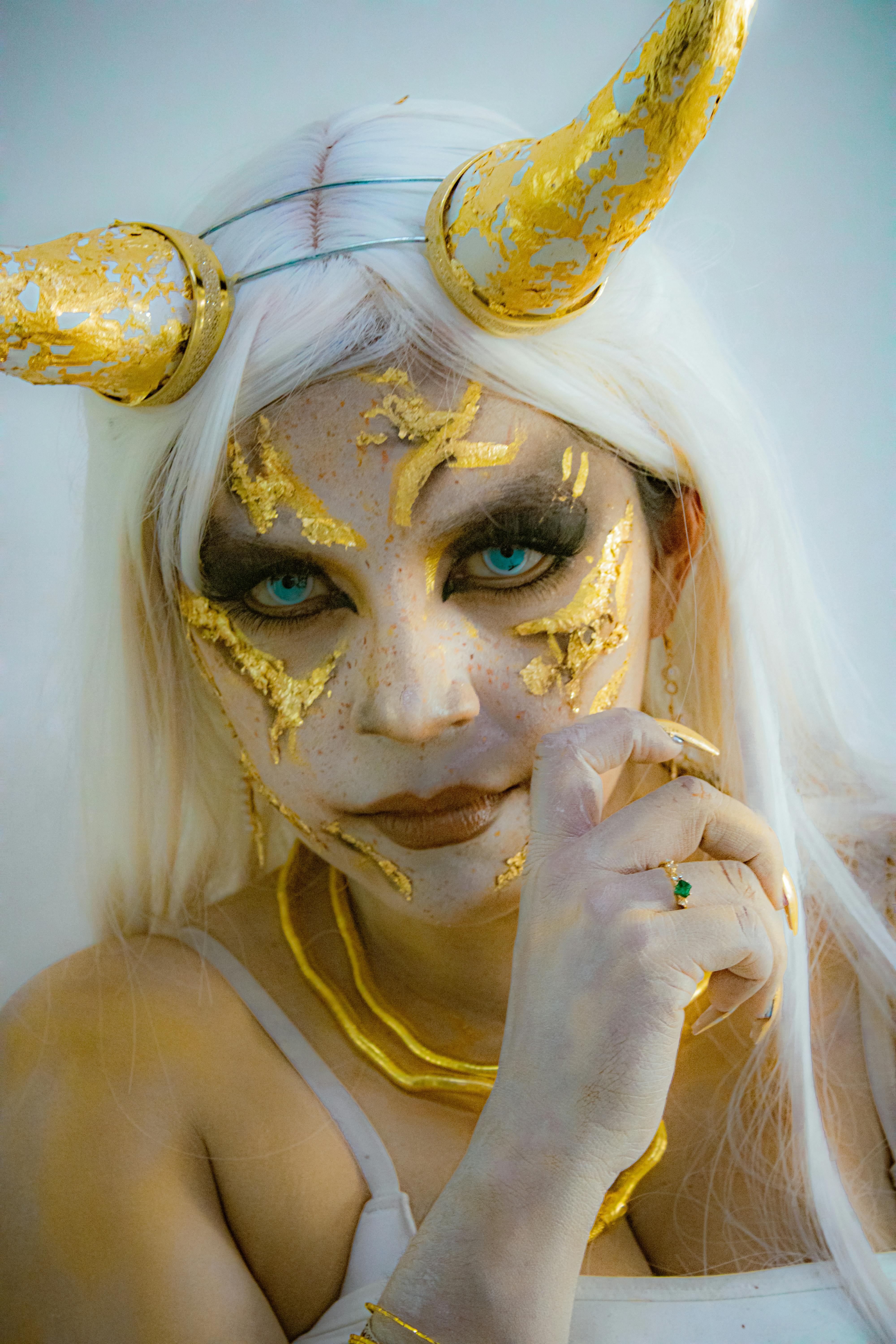 Artistic Makeup with Gold Accents and Demonic Theme