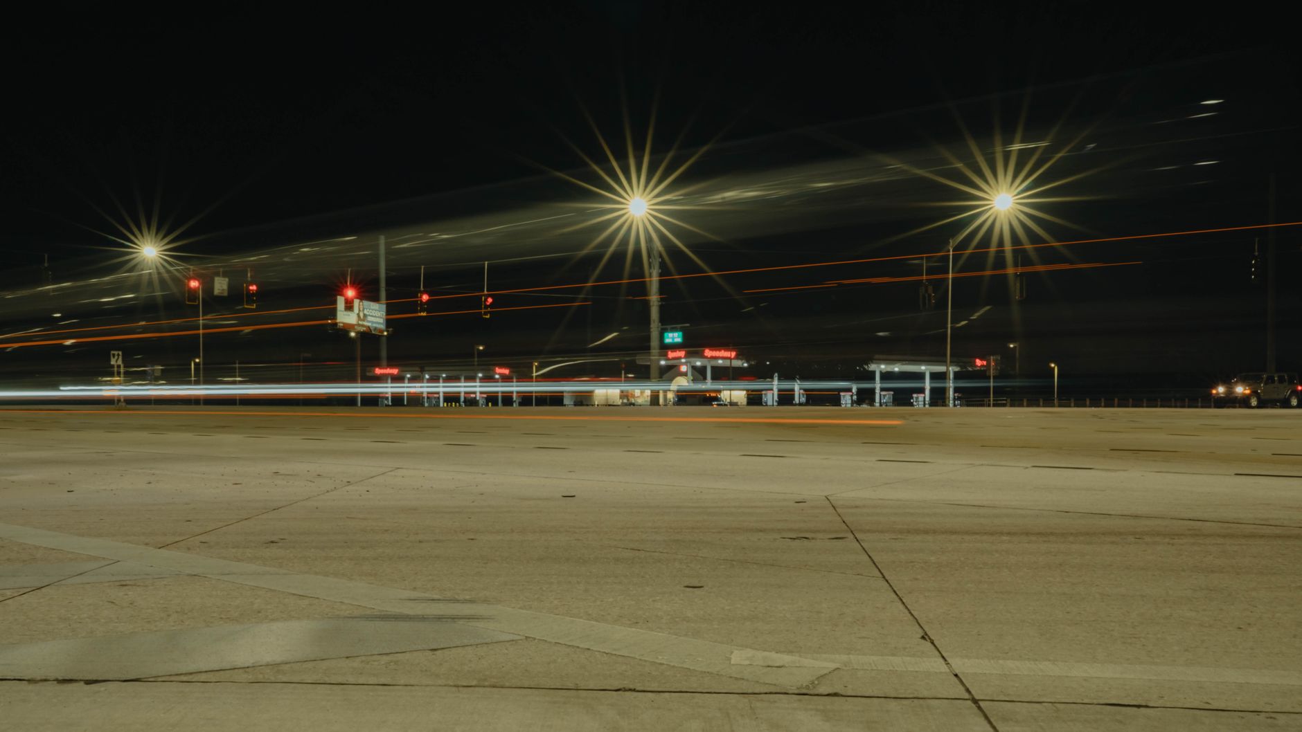 Long exposure of car lights at a Land O' Lakes, Florida intersection at night.