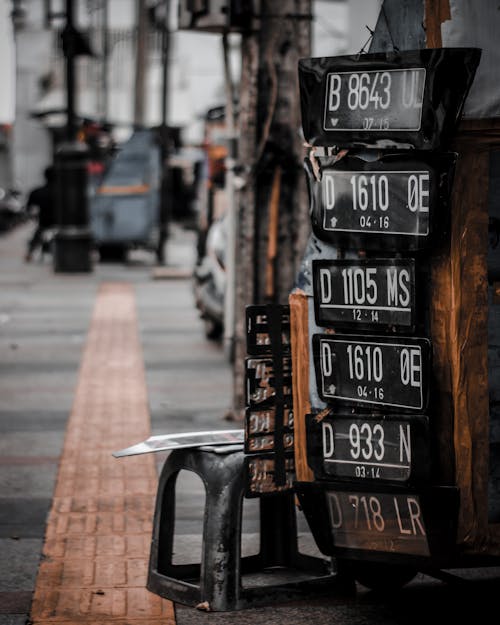 Selective Focus Photo of Lined Black-and-white Licensed Plates