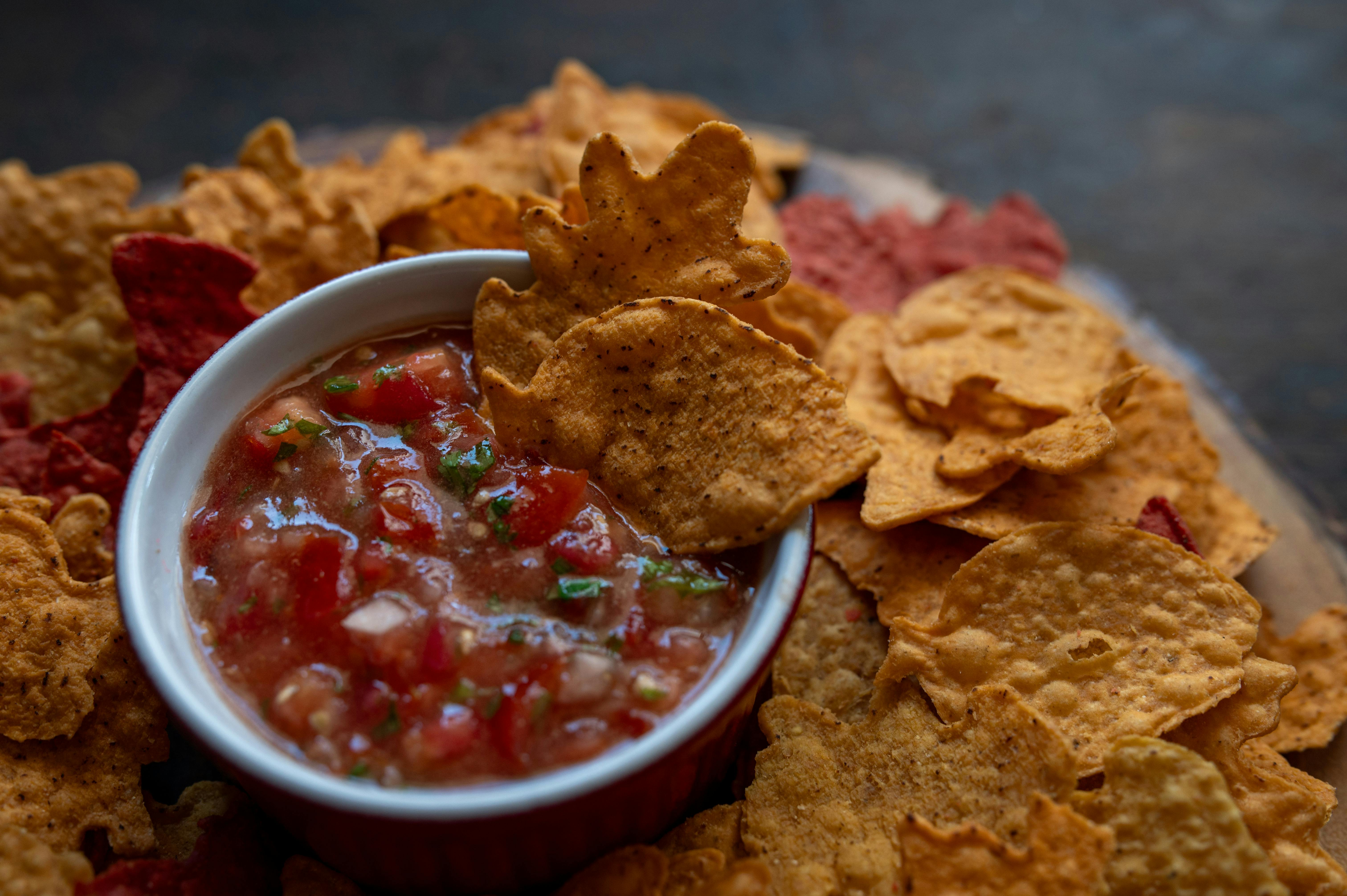 Close-up of tortilla chips with salsa, a perfect snack for gatherings.