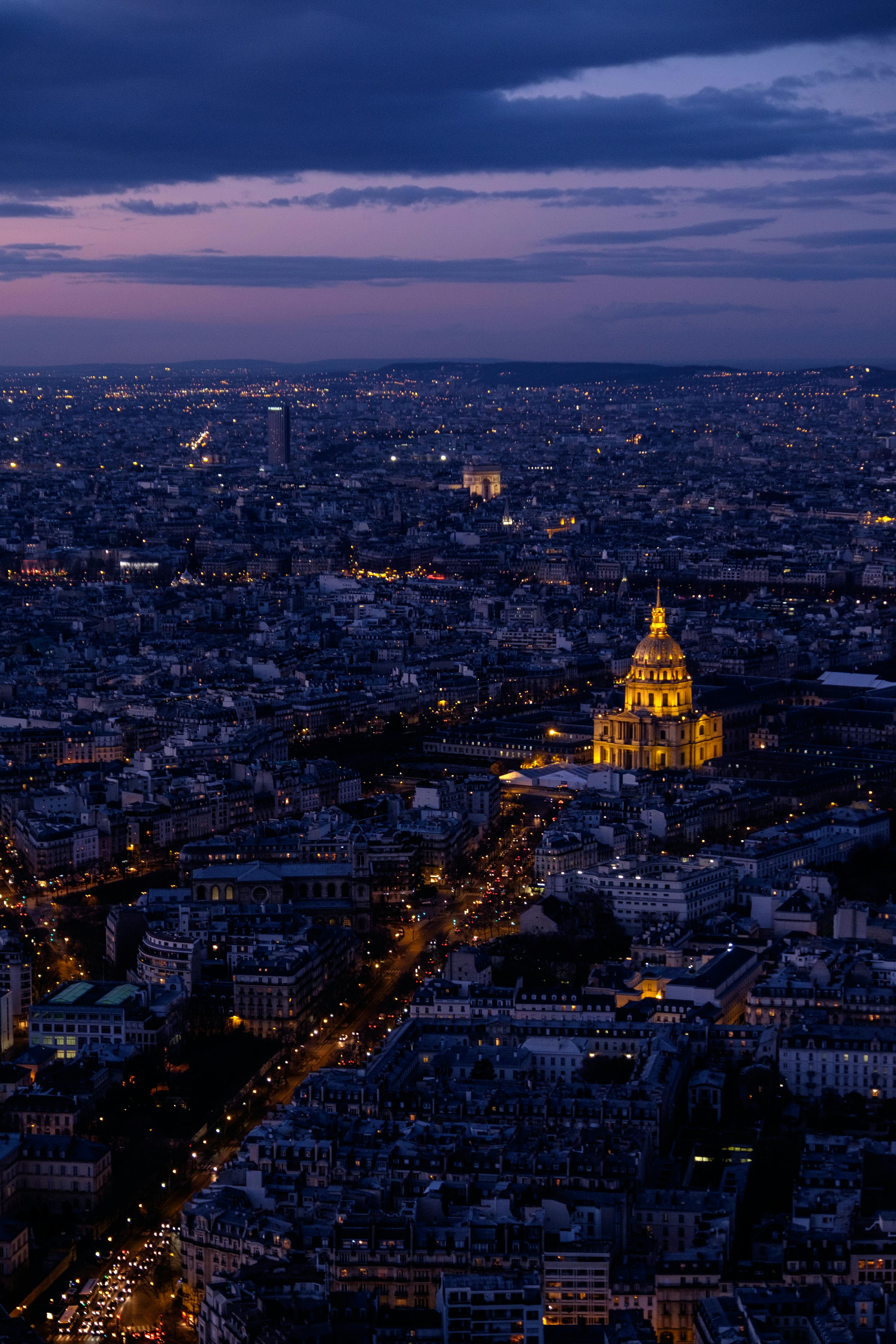 Captivating aerial night view of Paris with illuminated Les Invalides, showcasing the cityscape's beauty.