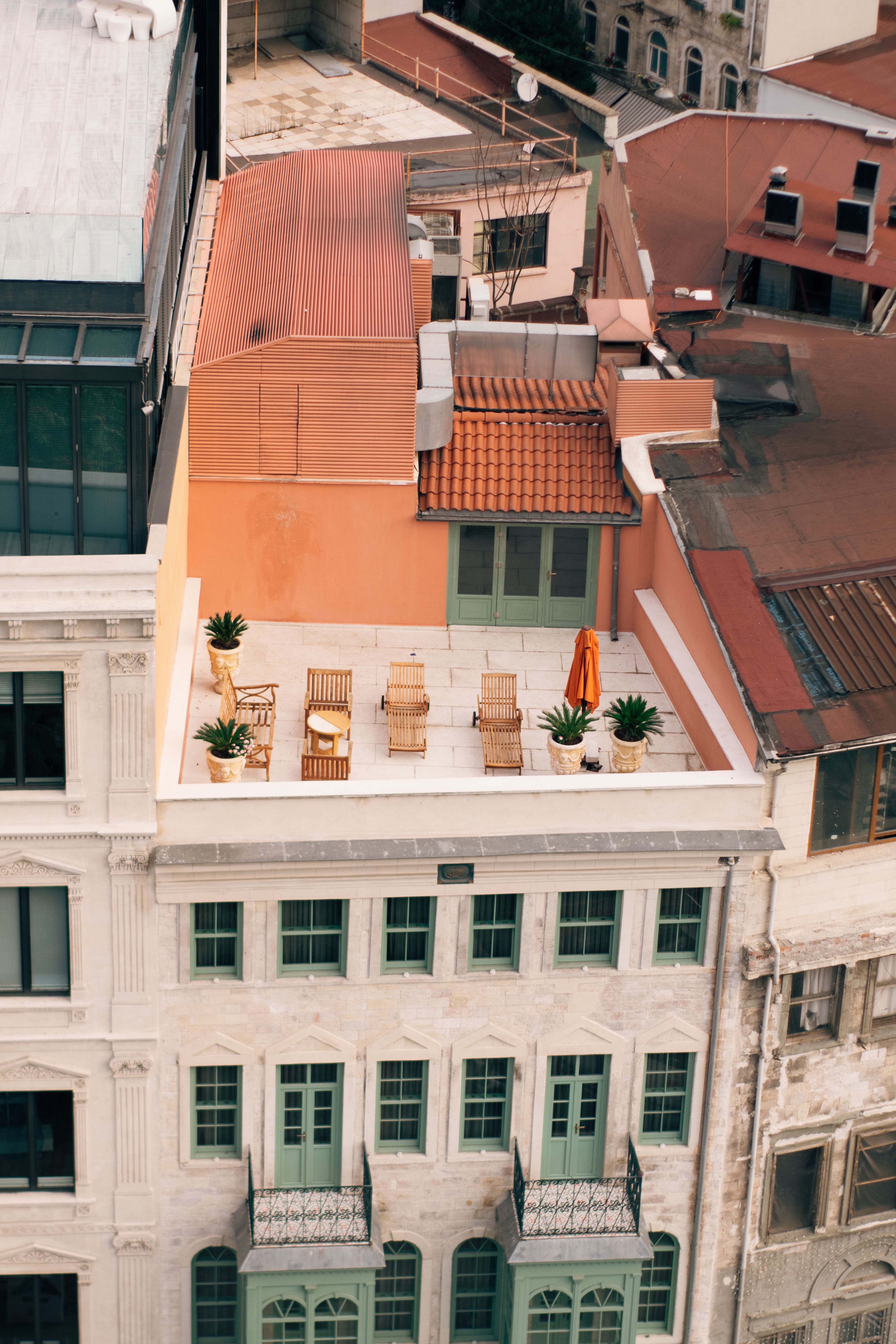 Urban rooftop deck with outdoor chairs and green plants