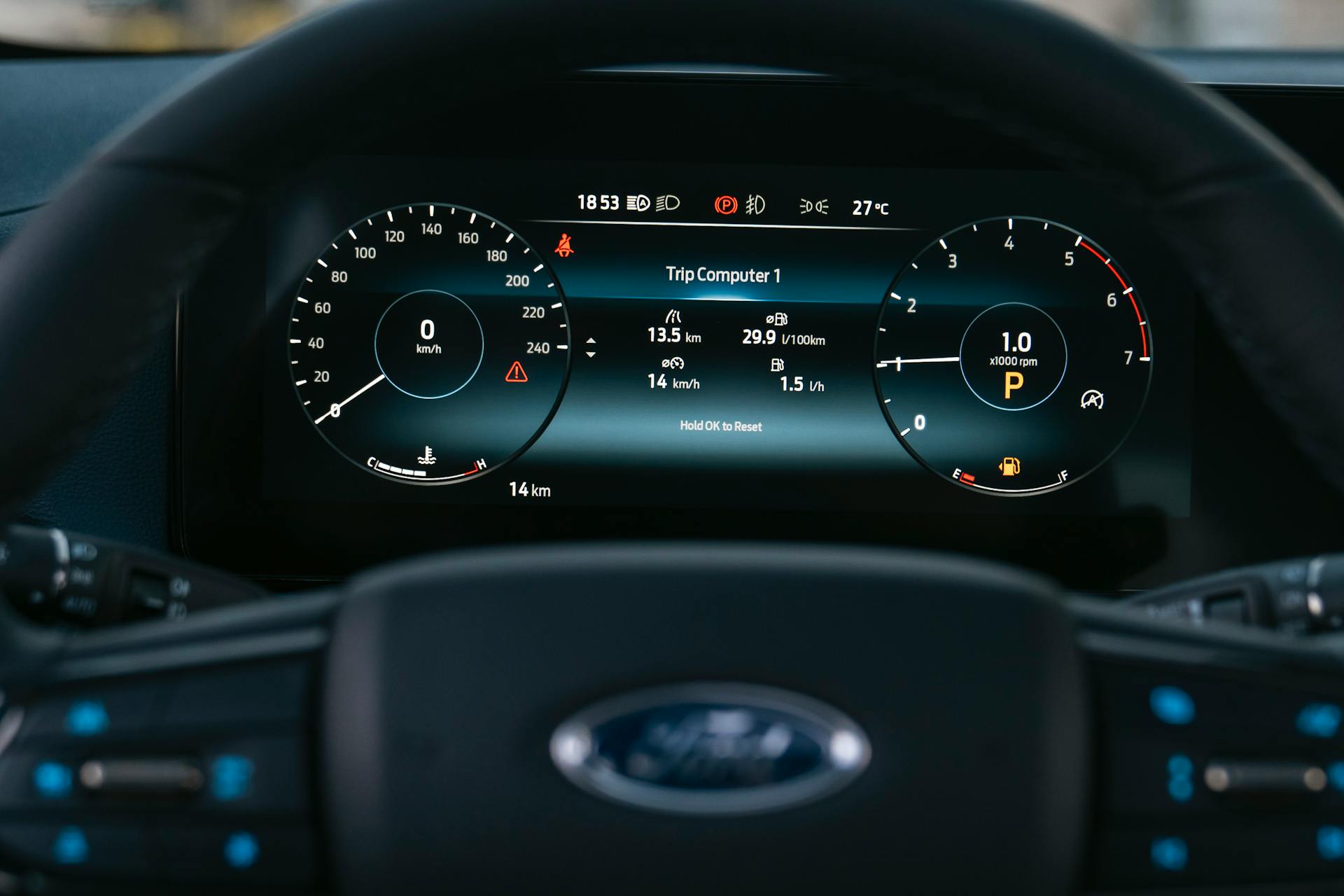 Interior car dashboard with digital display showing speed and trip computer information.