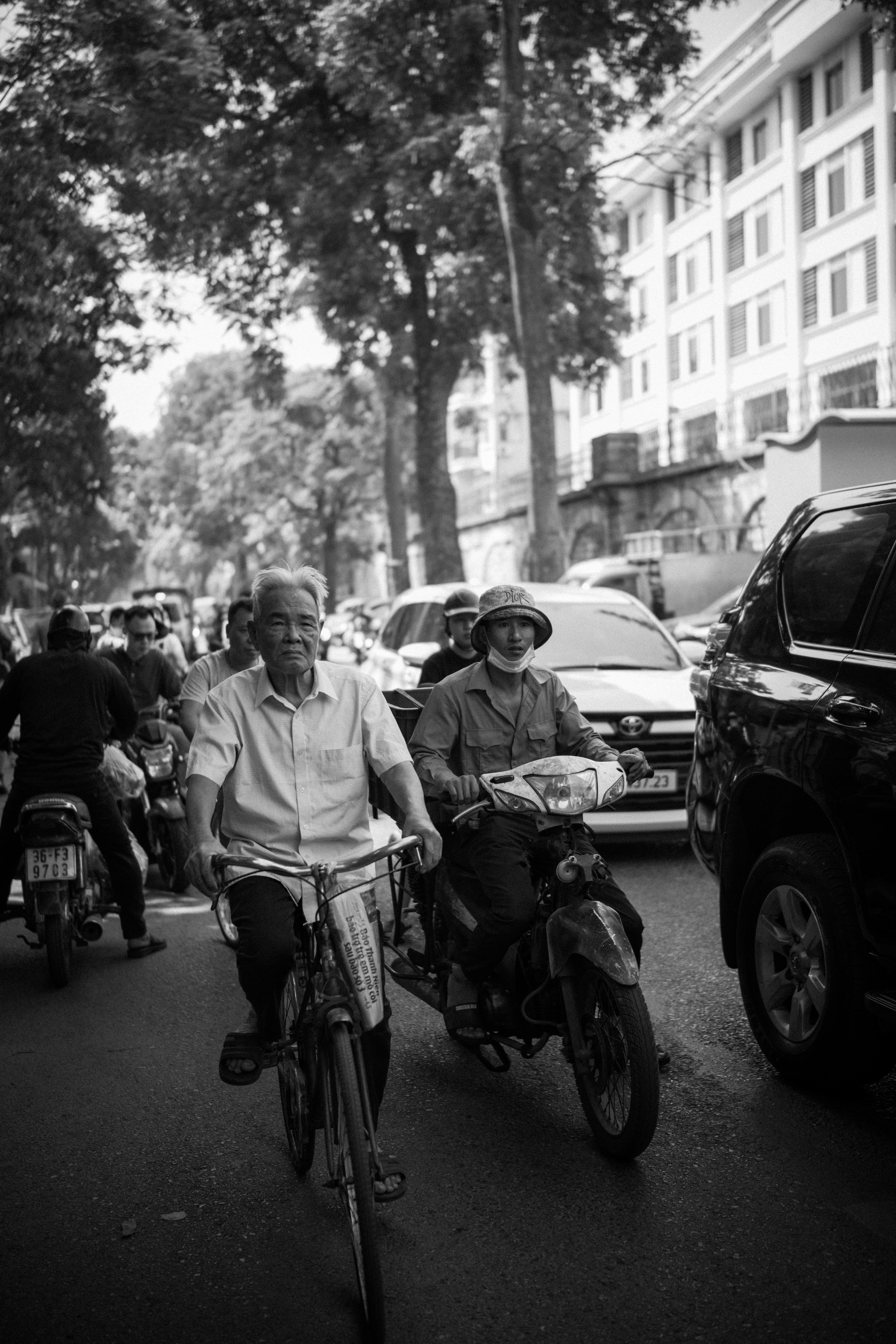 Captured in a bustling city, cyclists navigate through urban traffic.