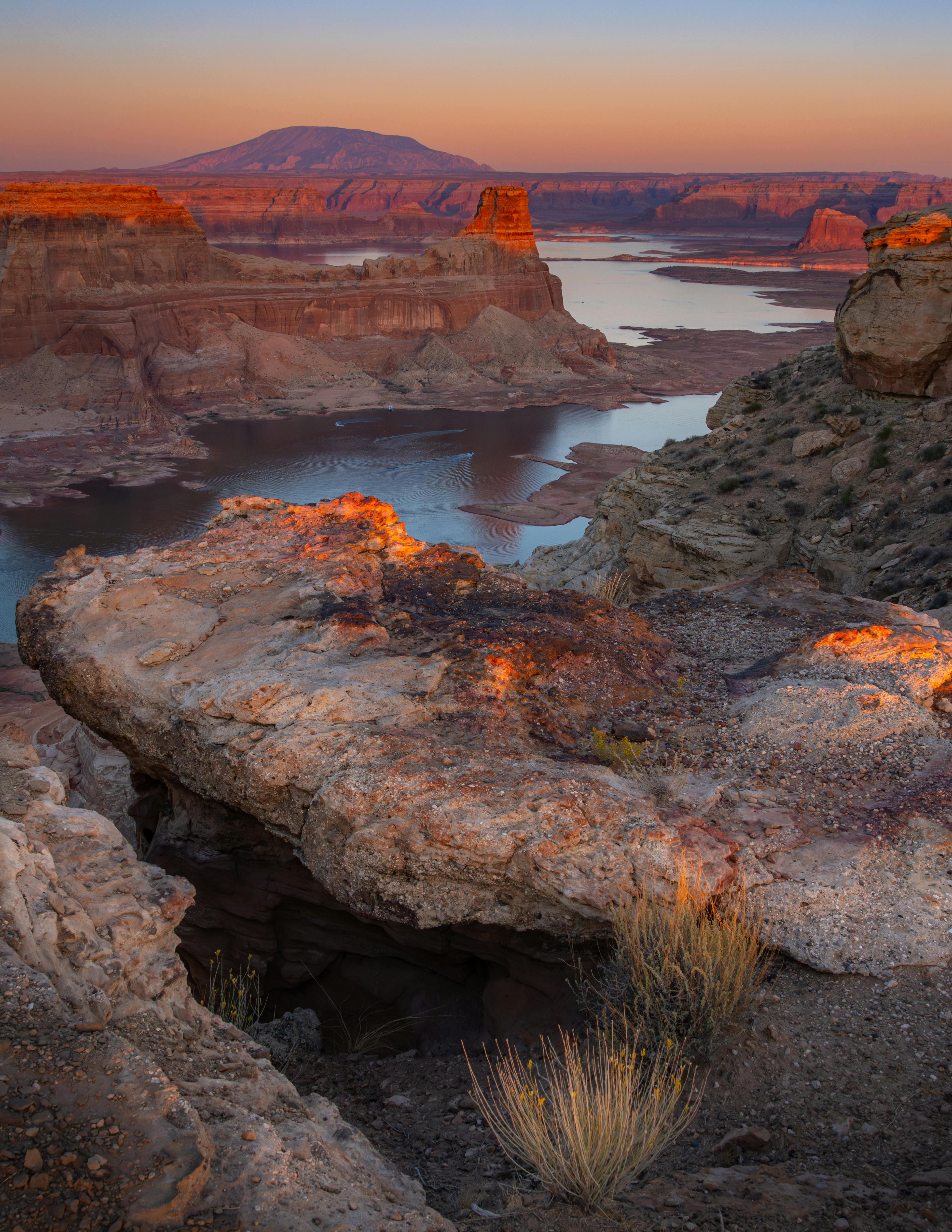 Breathtaking sunset over Lake Powell with dramatic rock formations and serene waters.