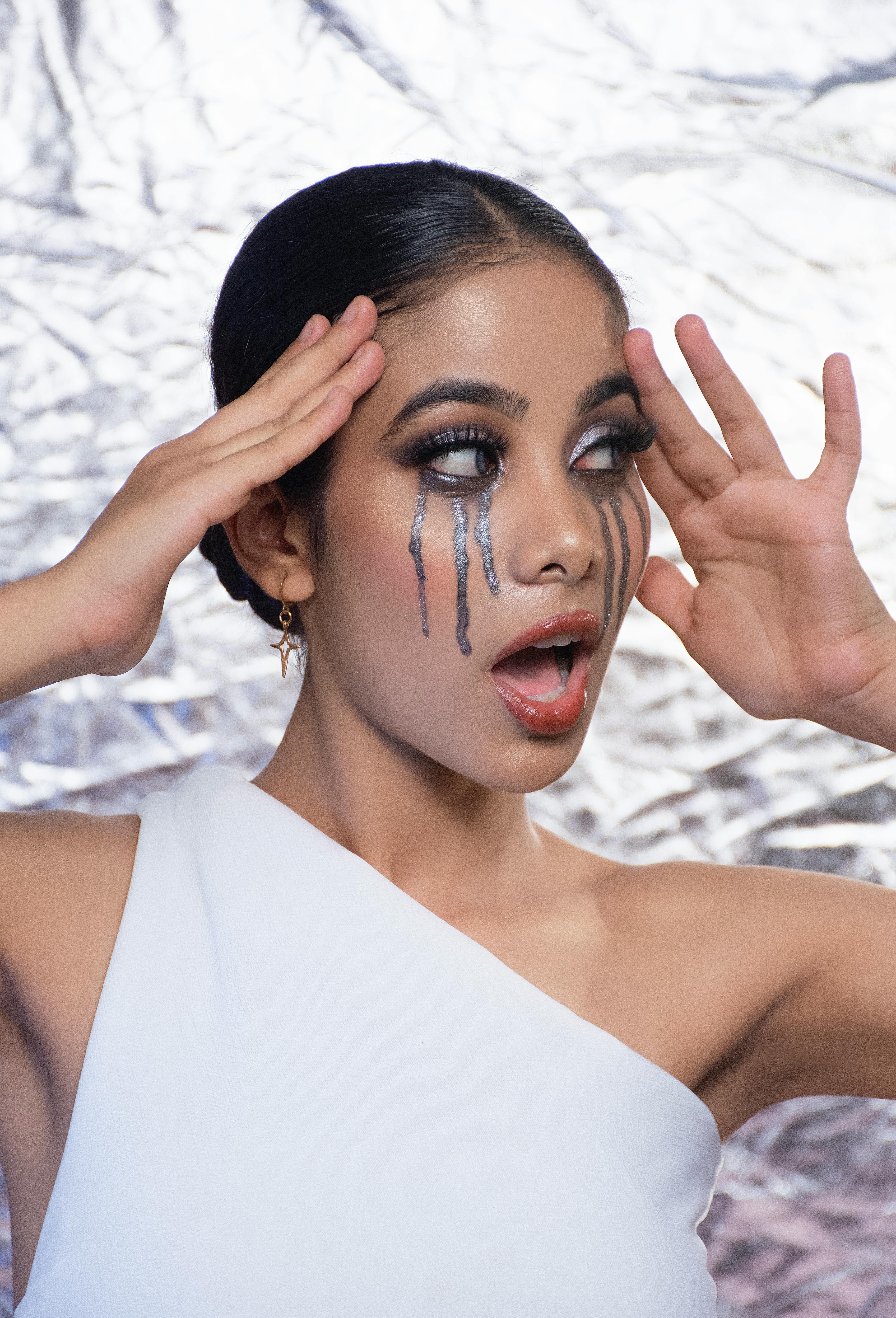 dramatic artistic makeup portrait with silver tears