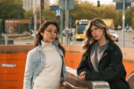 Two stylish women posing on a Berlin street, autumn day.