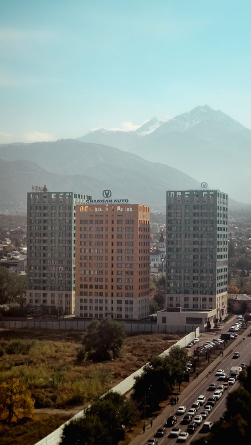 Free View of modern buildings with mountains in Almaty, Kazakhstan Stock Photo
