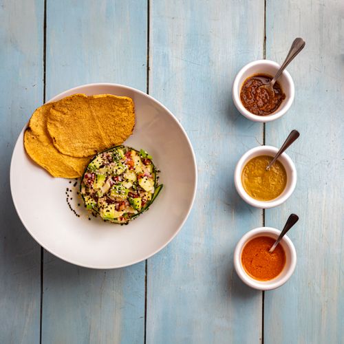 Free Top-down view of Mexican dish with sauces on a rustic blue table. Stock Photo