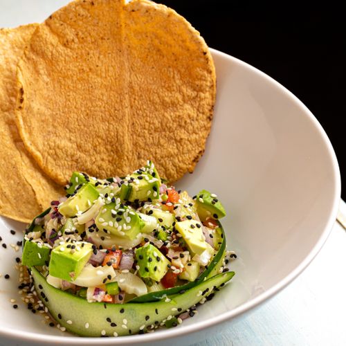 Free A vibrant aguachile dish featuring fresh avocado and sesame seeds, perfect for a summer meal. Stock Photo