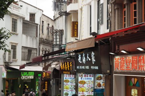 Free A lively street scene showcasing traditional Asian architecture and colorful shop signs. Stock Photo