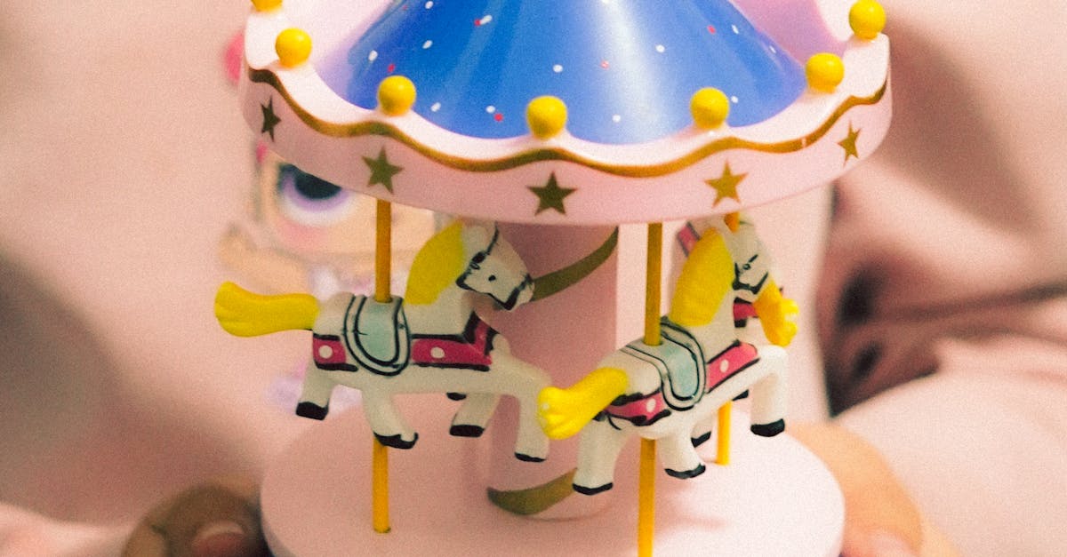 Colorful Miniature Carousel Music Box Held by Child · Free Stock Photo
