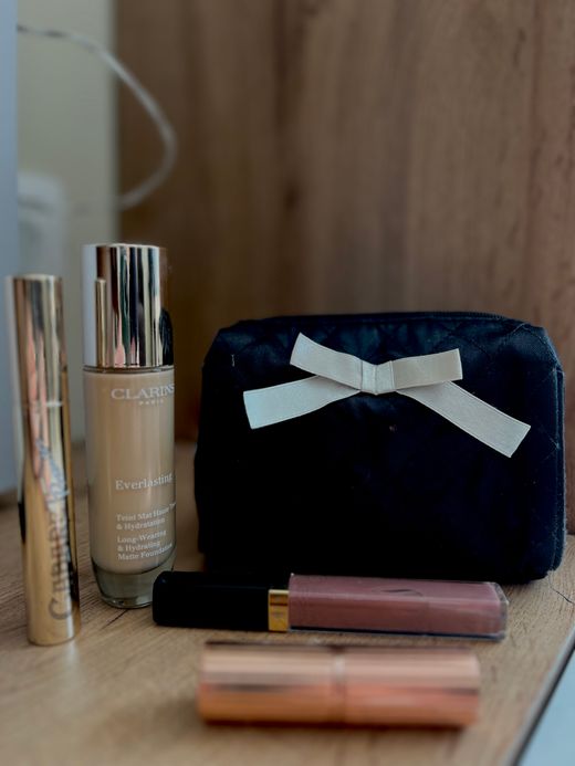 Beauty gift set with pouch, foundation and lip gloss &mdash; photo by Nana Petrova on Pexels