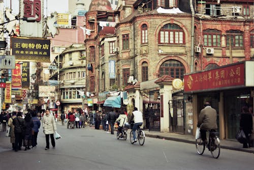 People on Street  Next to Buildings