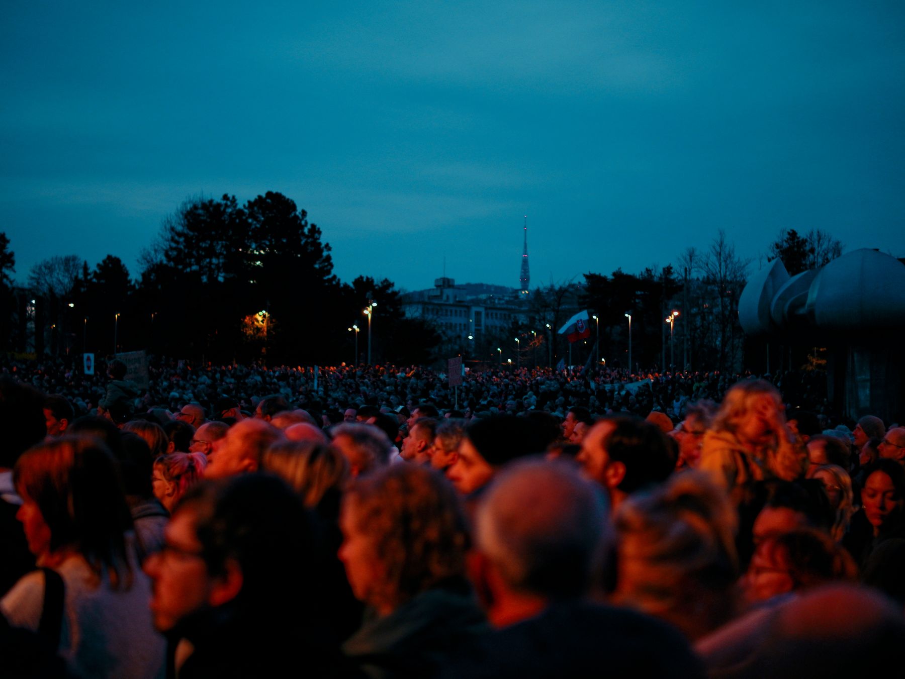 Crowd gathered outdoors at dusk under a deep blue sky — photo by William Gevorg Urban on Pexels