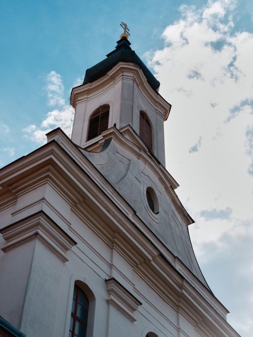 Free Elegant view of a historic church steeple under a serene blue sky. Stock Photo